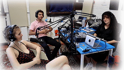 Three young people in a podcast studio